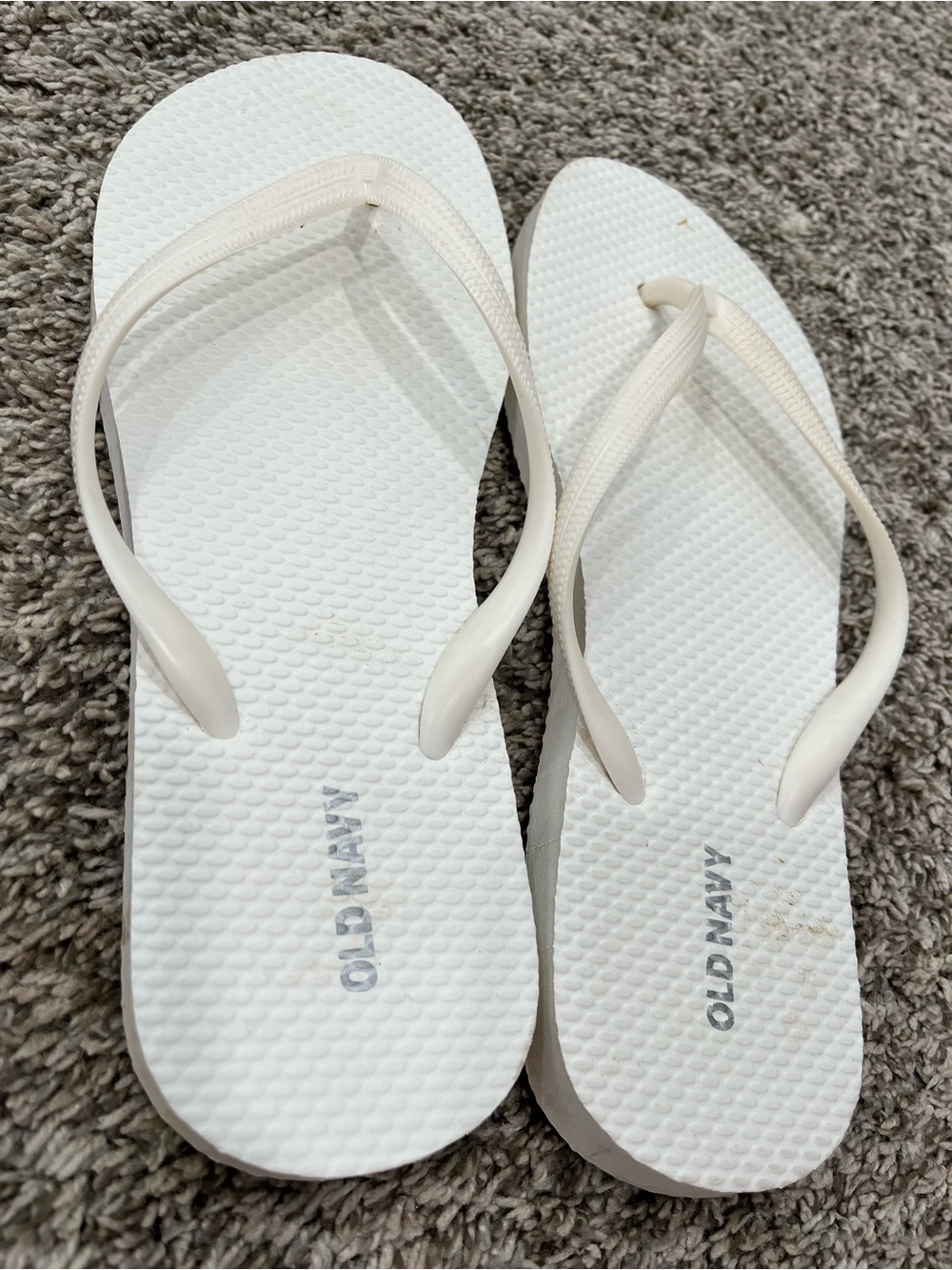 Worn Old Navy white flip flops